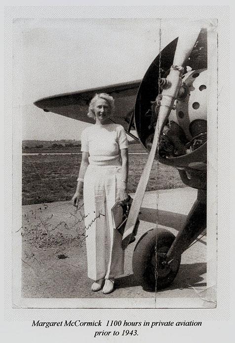 Margaret McCormick beside an airplane